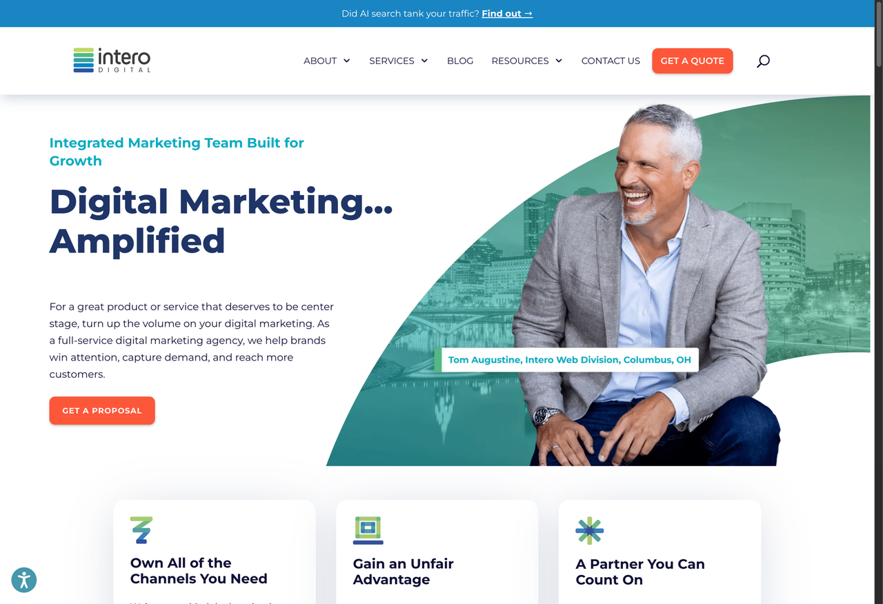Intero Digital homepage featuring the headline “Digital Marketing... Amplified” alongside a smiling business professional and marketing agency branding.